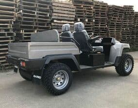 A UTV with stacks of pallets in the background